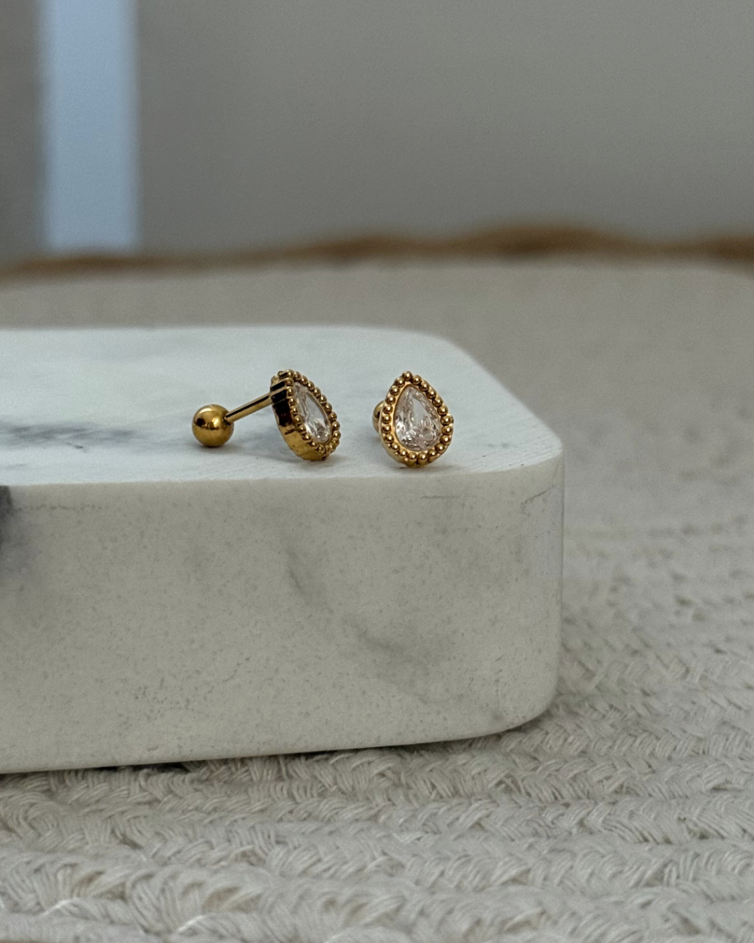 Piercing goccia grande indossato, elegante e luminoso.