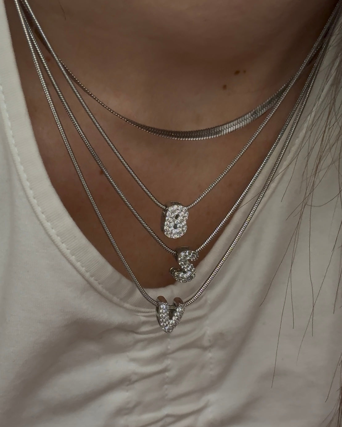 Collana in acciaio inossidabile con ciondolo in ottone decorato da zirconi, ideale come regalo elegante.